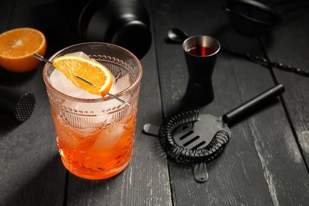 Bartender equipment and glass of cocktail on gray wooden background, closeupの写真素材