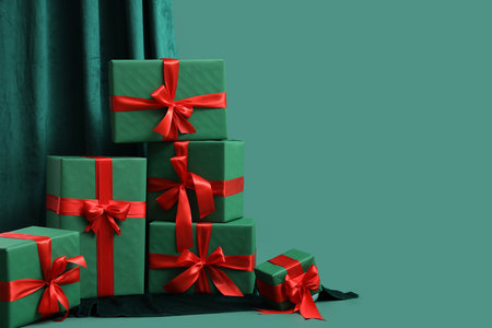 Many Christmas gifts and curtain on green backgroundの写真素材