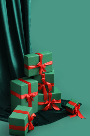 Many Christmas gifts and curtain on green backgroundの写真素材
