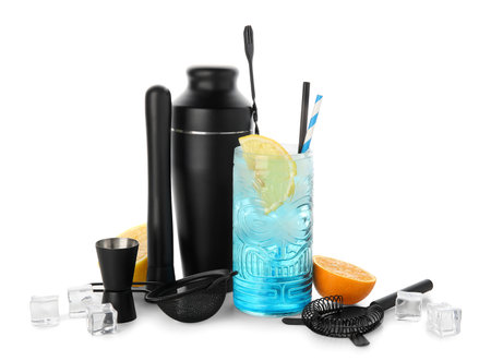 Glass of fresh cocktail and bartender tools isolated on white backgroundの写真素材