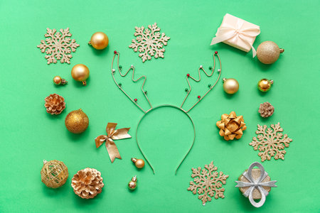 Christmas reindeer antlers headband with decor on green backgroundの写真素材