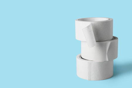Rolls of white masking tape on blue backgroundの写真素材