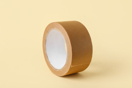 Roll of brown masking tape on beige backgroundの写真素材