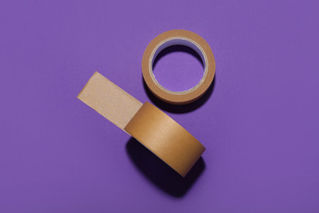 Rolls of brown masking tape on purple backgroundの写真素材