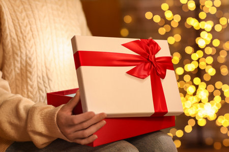 Woman with beautiful gift box at home on Christmas Eve, closeupの写真素材
