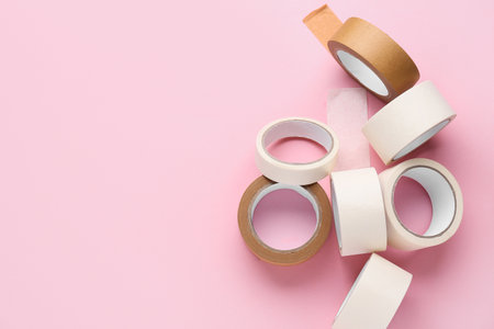 Many rolls of different masking tape on pink backgroundの写真素材