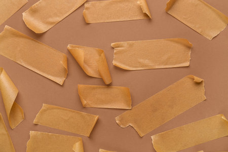 Many pieces of masking tape on brown backgroundの写真素材