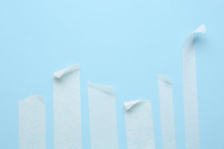 Strips of white masking tape on blue backgroundの写真素材