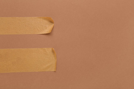 Strips of masking tape on brown backgroundの写真素材