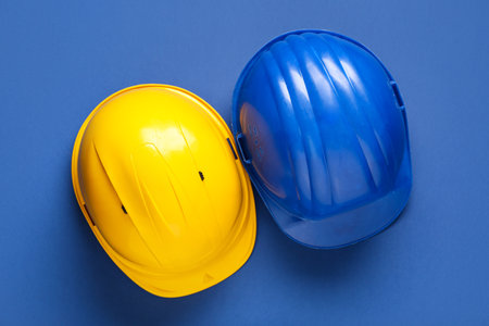 Hardhats on blue background, top viewの写真素材