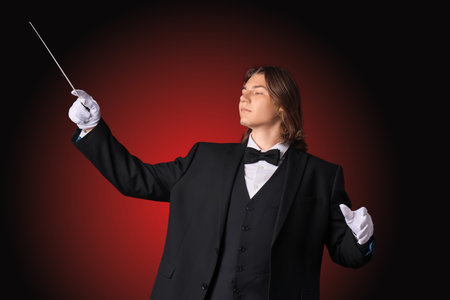 Male conductor on dark red background