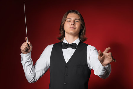 Male conductor on red backgroundの写真素材