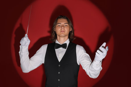 Male conductor on red backgroundの写真素材
