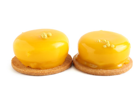 Tasty lemon mousse cakes on white backgroundの写真素材