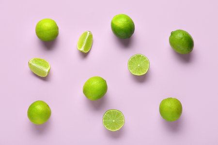Fresh ripe limes on lilac backgroundの写真素材
