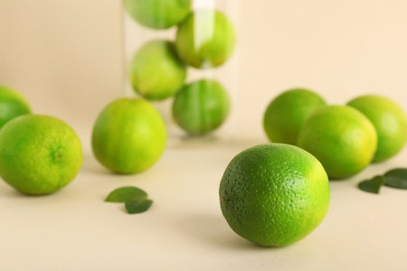 Fresh ripe limes on beige backgroundの写真素材