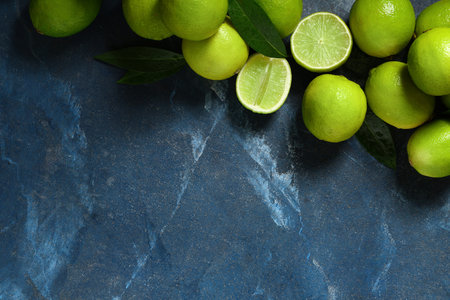 Fresh ripe limes on blue background