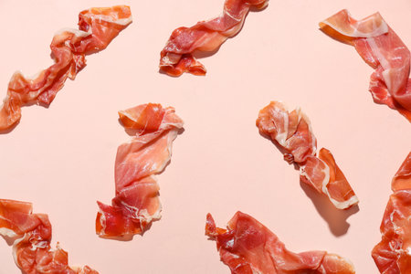 Delicious prosciutto slices on pink backgroundの写真素材