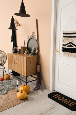 Interior of hallway decorated for Halloween with door, commode and witch hatsの写真素材