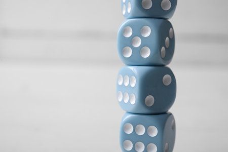 Stack of blue game dices on white backgroundの写真素材