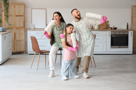 Happy family with pp-dusters singing while cleaning in kitchen