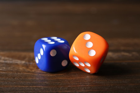 Different game dices on wooden backgroundの写真素材