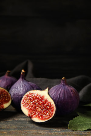 Composition with fresh ripe figs on black wooden background, closeupの写真素材