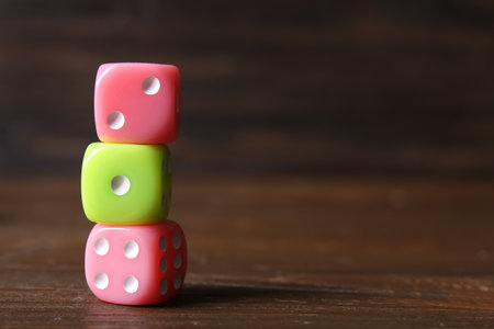 Stack of different game dices on wooden backgroundの写真素材