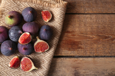 Fresh ripe figs on wooden background