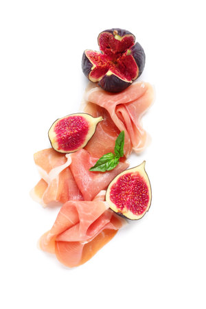 Delicious prosciutto slices with fresh figs and basil leaves on white backgroundの写真素材
