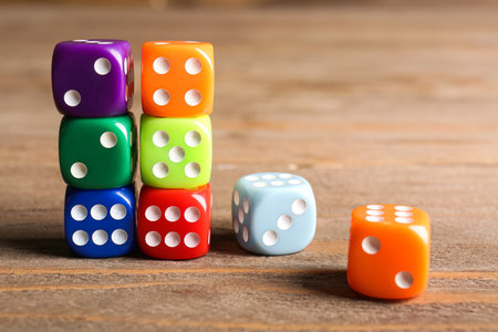 Colorful dices on wooden background