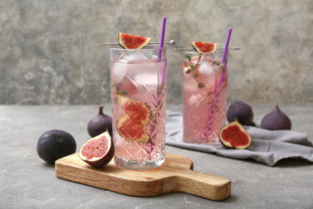 Composition with glasses of fresh fig lemonade on gray grunge table, closeupの写真素材