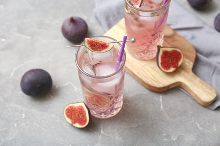 Composition with glasses of fresh fig lemonade on gray grunge background, closeupの写真素材