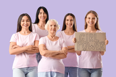 Group of beautiful women holding cardboard with text GIRL POWER on lilac background. Feminism conceptの写真素材