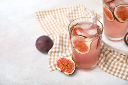 Glasses of tasty fig lemonade on white background, closeupの写真素材