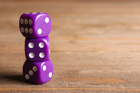 Purple dices on wooden backgroundの写真素材