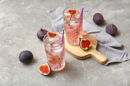 Composition with glasses of fresh fig lemonade on gray grunge background, closeupの写真素材