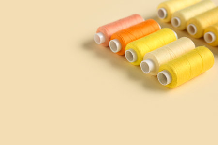 Thread spools on beige background