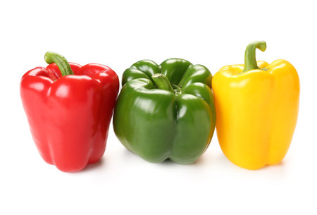 Fresh colorful bell peppers on white backgroundの写真素材