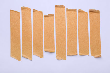 Strips of brown masking tape on white backgroundの写真素材