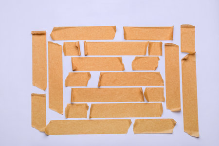 Strips of brown masking tape on white backgroundの写真素材