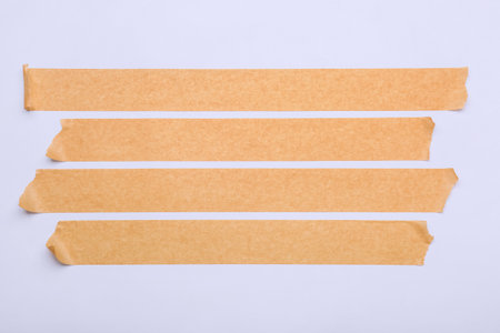 Strips of brown masking tape on white backgroundの写真素材