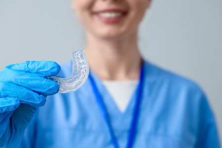 Female dentist with splint on gray background, closeupの写真素材