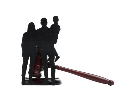 Judge's gavel with figures of family isolated on white backgroundの写真素材