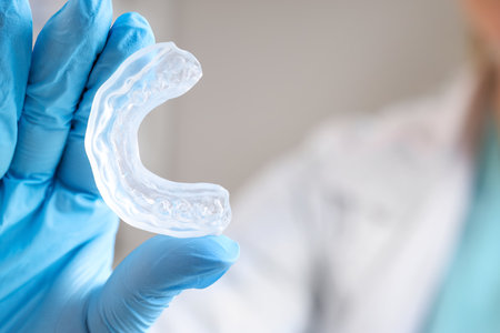 Female dentist with occlusal splint in clinic, closeupの写真素材