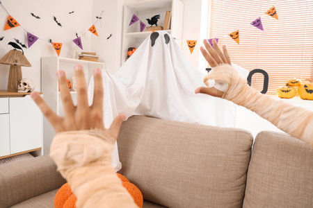 Children dressed for Halloween at homeの写真素材