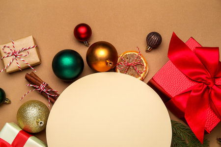 Blank card with Christmas balls and gift boxes on brown backgroundの写真素材