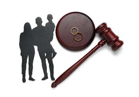 Judge's gavel with figures of family and rings isolated on white backgroundの写真素材