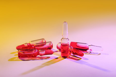 Glass ampoules on color backgroundの写真素材
