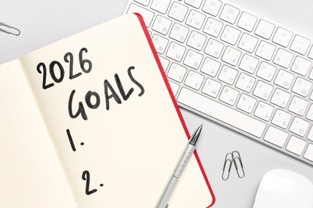 Notebook with 2026 goals and computer keyboard on light backgroundの写真素材